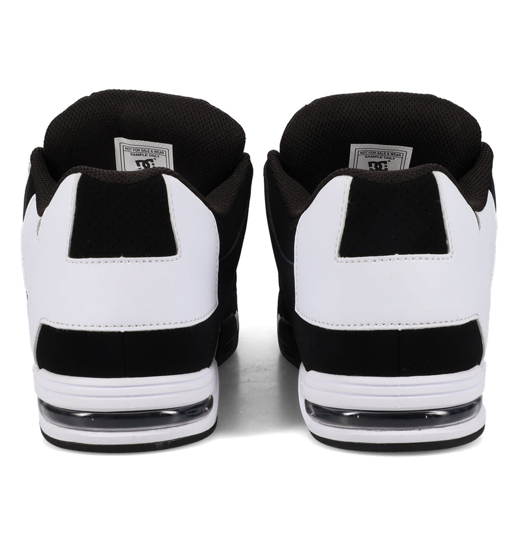 A pair of Men’s Command Shoes by DC Shoes in black and white, shown from the back, feature signature heel cushioning, visible air soles, a textured black interior, and classic DC bulk highlighted with white accents.