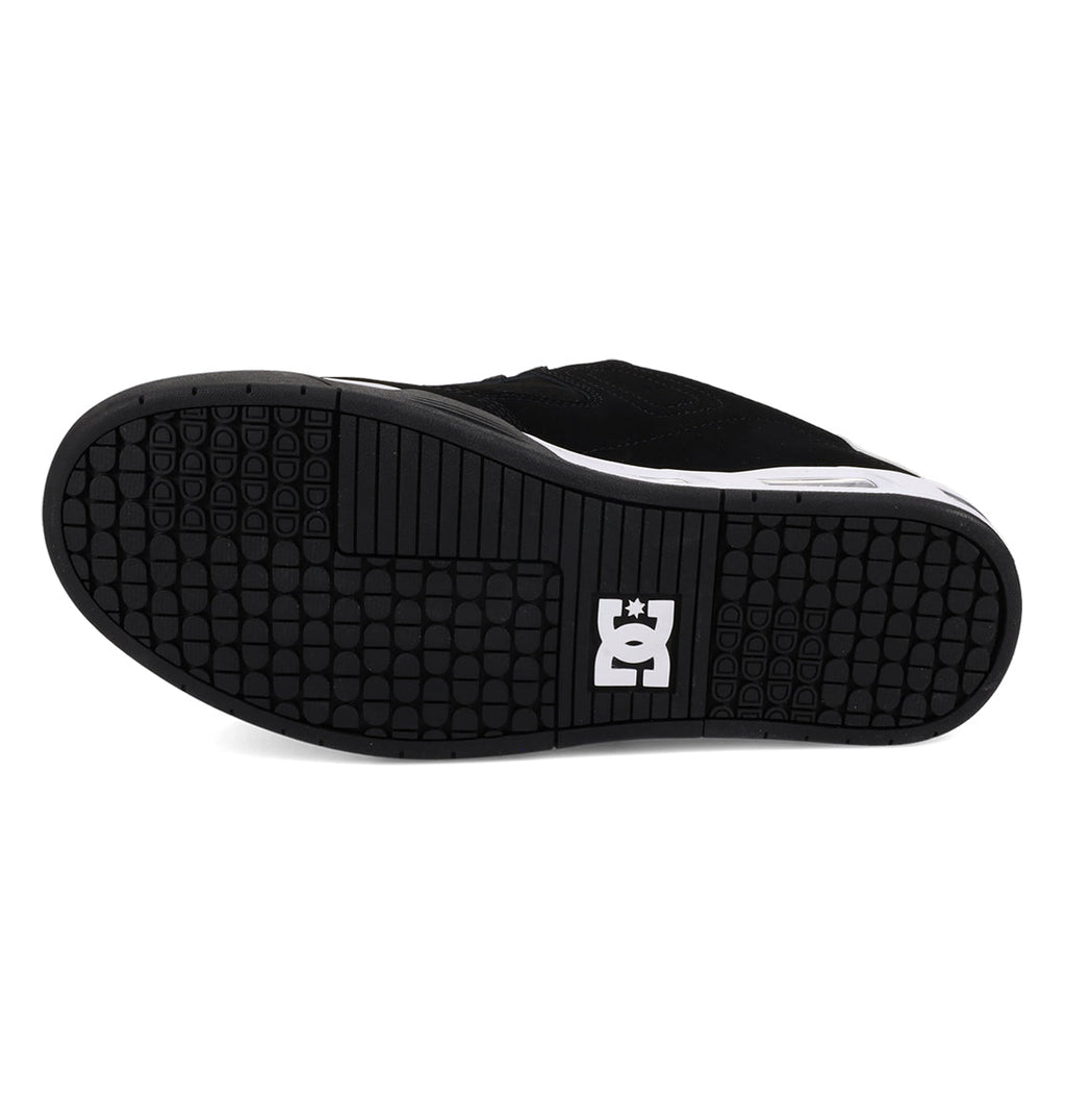 The underside of a black Men’s Command Shoe by DC Shoes, featuring a textured rubber sole with the white DC logo near the heel and signature DC bulk for enhanced durability.