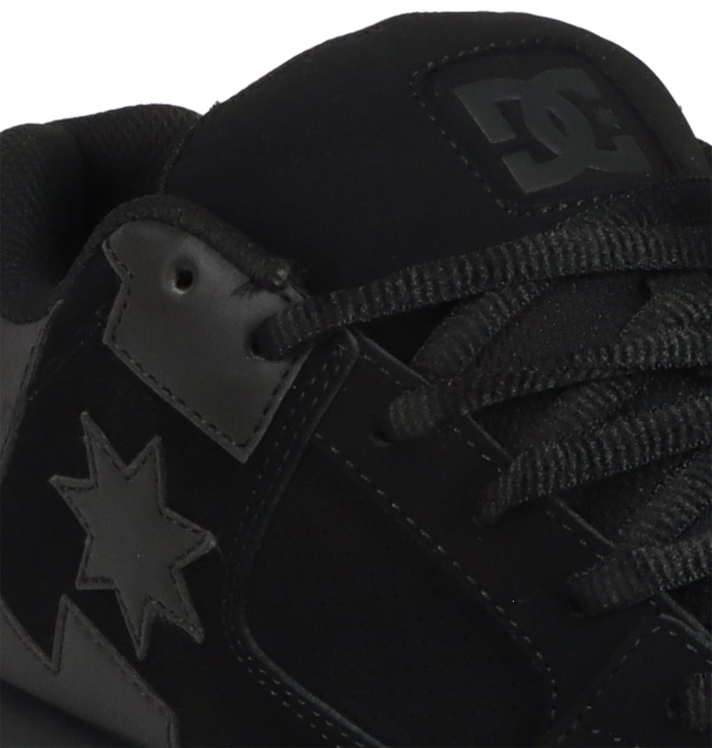Close-up of the DC Shoes Men’s Command skate shoe in black, featuring black laces, a star logo on the side, and the DC logo on the tongue. This style delivers signature cushioning and classic DC bulk for enduring comfort and support.