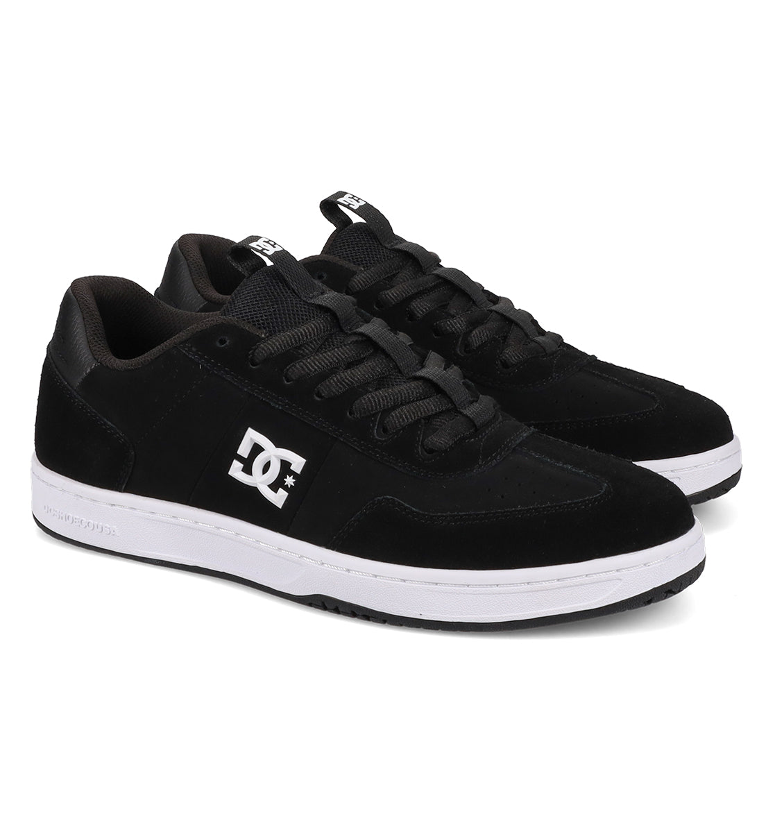 A pair of Men’s Astrix Shoes by DC Shoes in black, featuring white soles and the signature DC logo on the side, designed for optimal board control. The shoes are positioned side by side, facing slightly to the right.