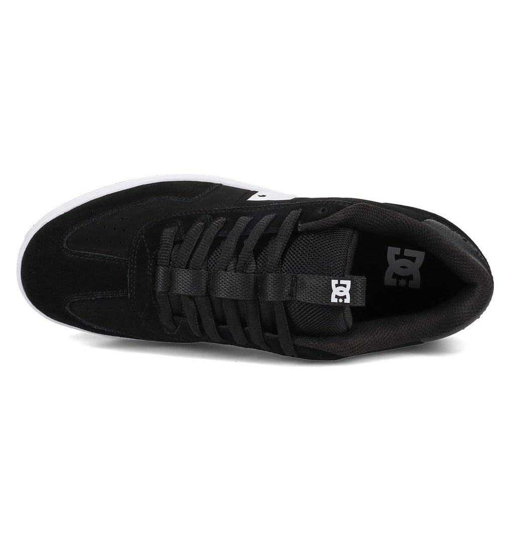 Top view of the Men’s Astrix Shoe by DC Shoes in black, featuring black laces, a white sole, and a small logo tag on the tongue. Designed for superior board control during street skateboarding sessions, the insole displays a white DC logo near the heel.