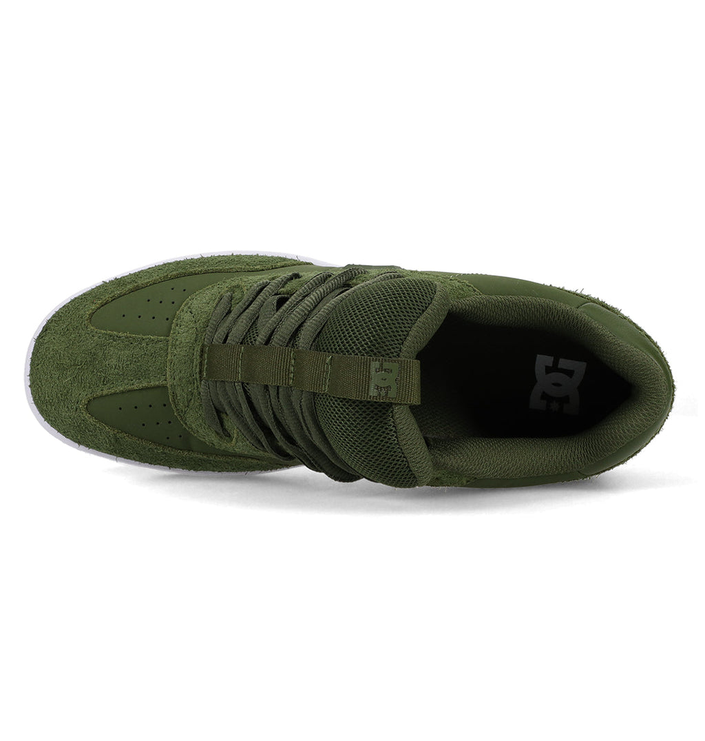 Top view of the Men’s Astrix Shoe by DC Shoes in green, featuring laces, a perforated toe area, and a white DC logo on the insole. Designed for street skateboarding, this shoe offers optimal board control with its white sole—partly visible along the bottom edge.