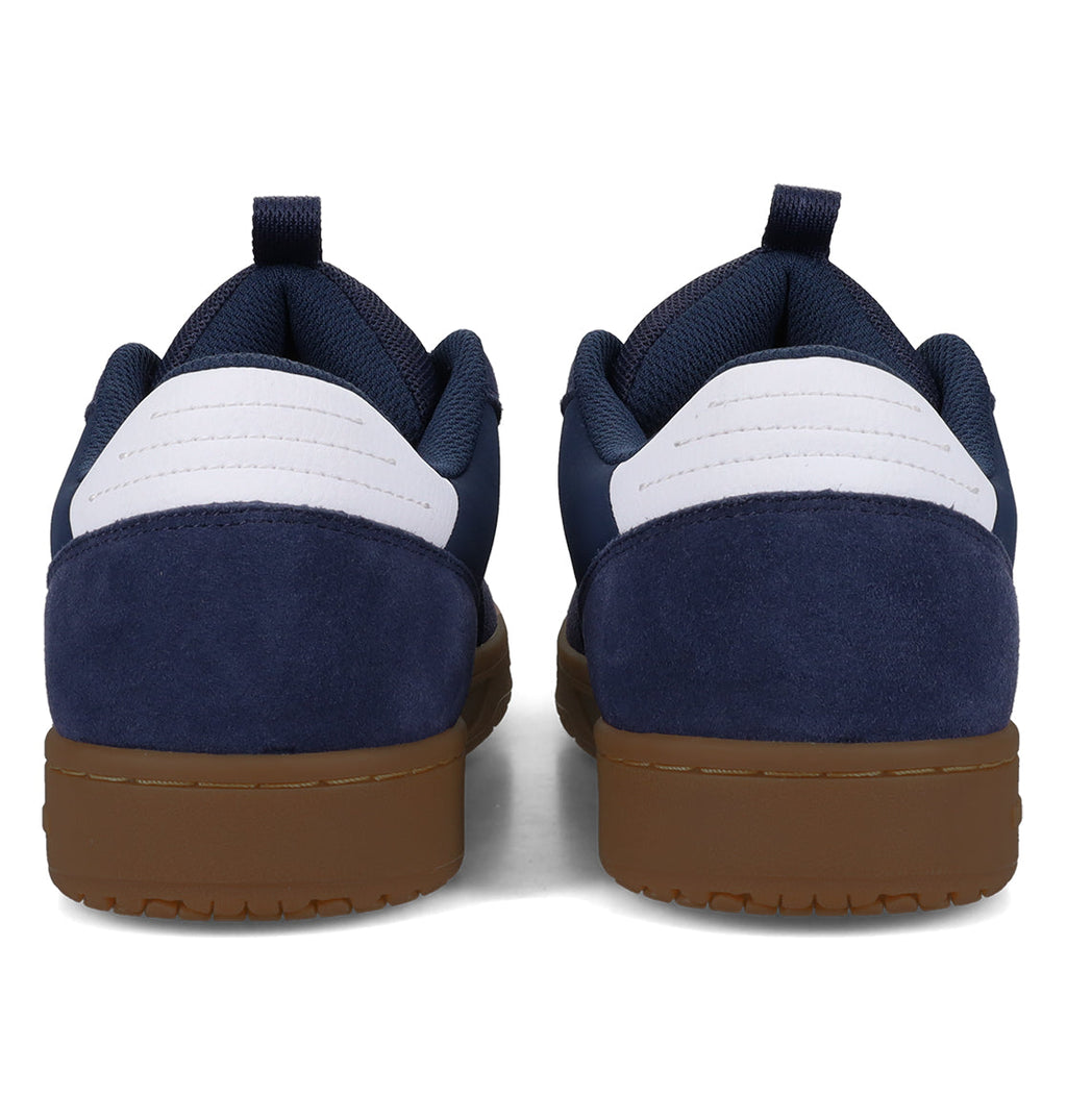 A pair of Men’s Astrix Shoes by DC Shoes in navy and white, featuring low-top suede heel panels and convenient pull tabs, are shown from the back with gum soles—ideal for street skateboarding and delivering excellent board control.