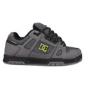 The DC Shoes Men's Stag features a gray upper with black accents, perforated details, black laces with white specks, and a black-and-yellow DC logo. It has a chunky silhouette, durable cupsole, and a black and gray sole for true skate style.