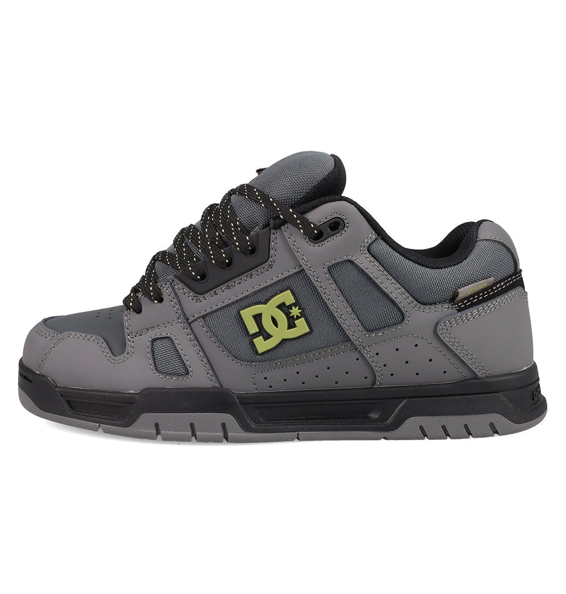 The DC Shoes Men's Stag Shoes feature a gray upper with black laces, black sole, yellow DC logo, padded tongue and collar, perforated details for breathability, and a durable cupsole inspired by skate culture.