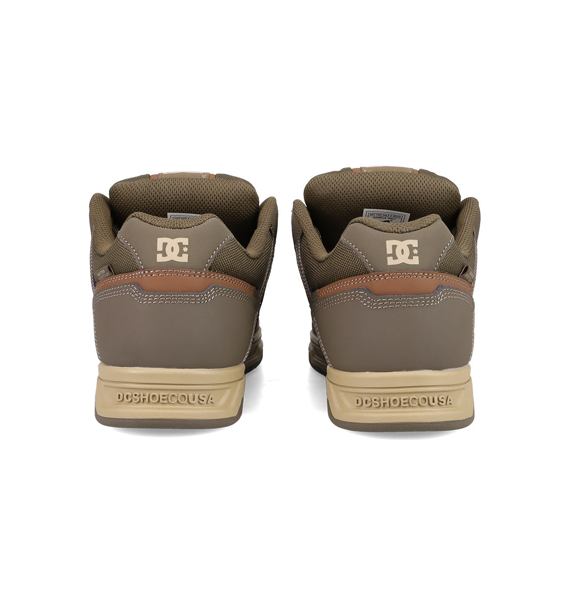 The Men's Stag Shoes by DC Shoes are shown from the back, featuring the DC Shoes logo on the heels, “DCSHOECOUSA” text on the soles, and tan and brown detailing with classic skate-inspired cupsole construction.