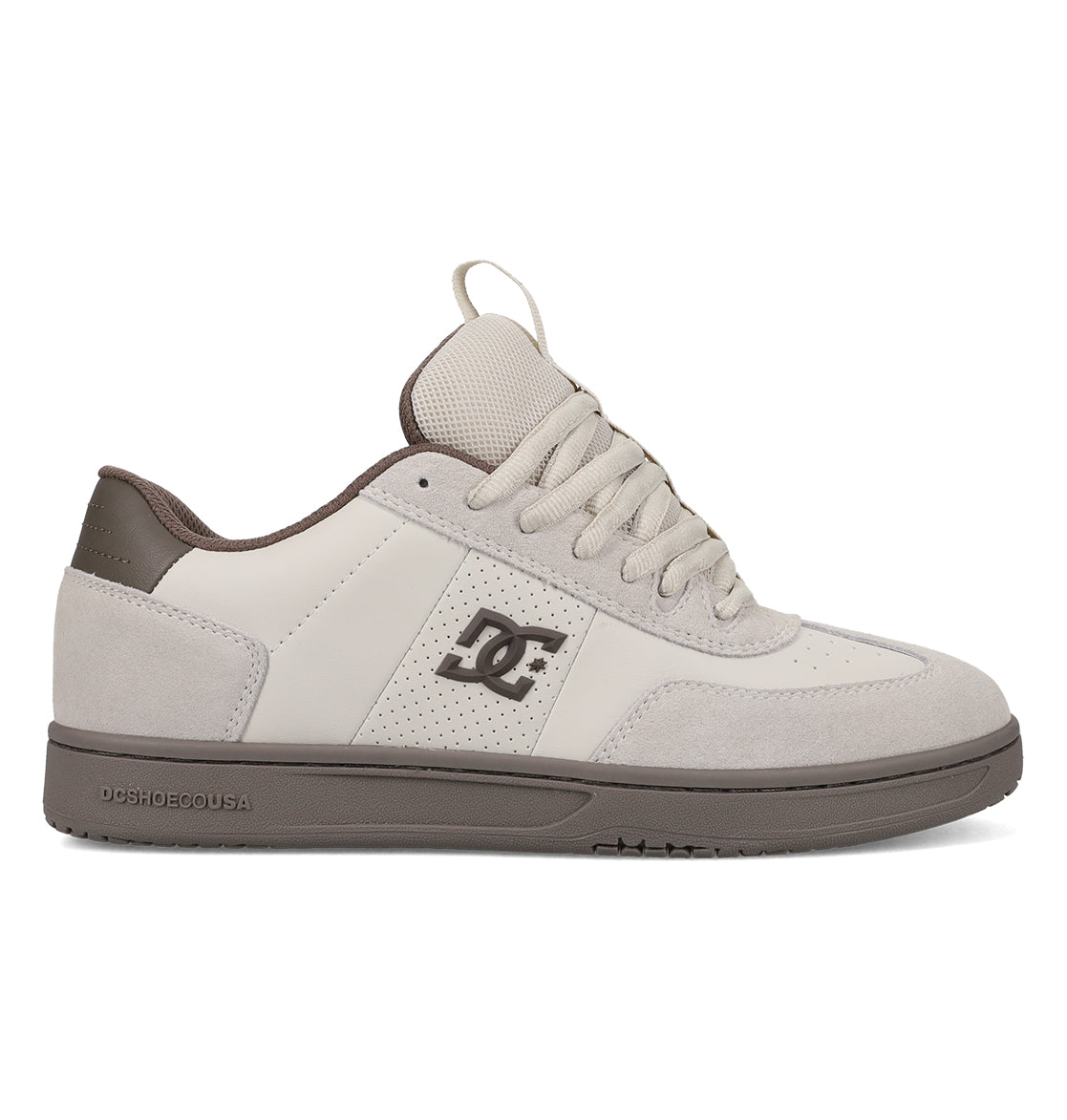 The DC Shoes Men’s Astrix Shoes feature a beige and gray colorway with a combination of leather and suede on the upper, a signature DC logo on the side, laces, and a durable rubber sole. Engineered for optimal board control, these skate shoes are shown in a side view against a white background.