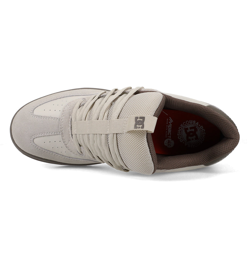 Top view of the Men’s Astrix Shoe from DC Shoes in light gray, featuring laces, a mesh tongue with the DC logo, brown inner lining, and branding on the insole—engineered for superior board control and ideal for street skateboarding.