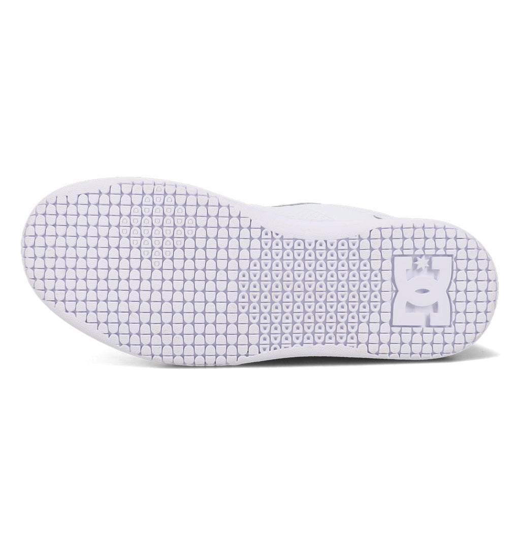The image shows the white sole of the Women’s Astrix Shoes by DC Shoes, featuring a textured grip pattern tailored for street skateboarding and a DC Shoes logo near the heel, ensuring optimal board control.