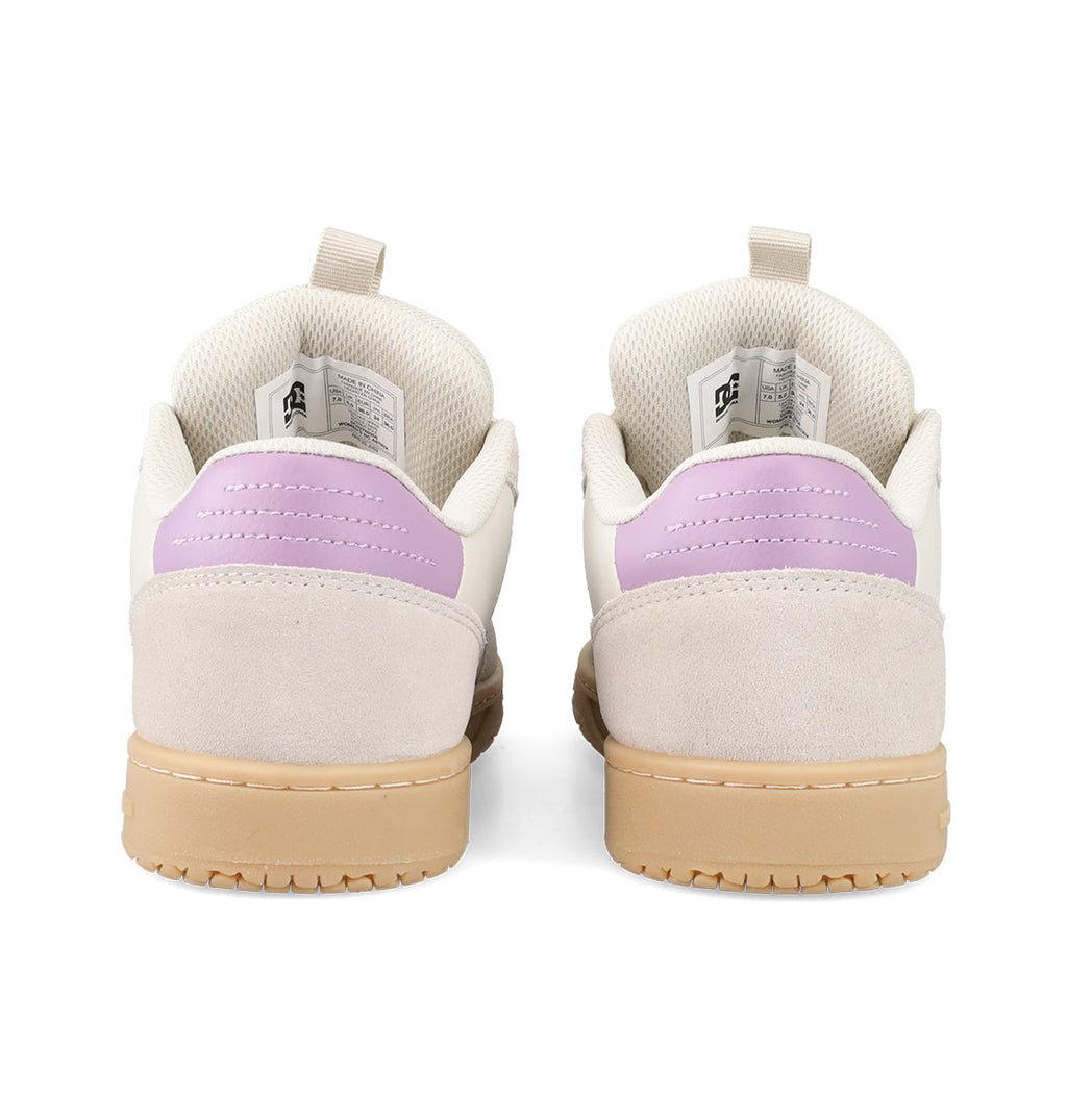 The Women’s Astrix Shoes by DC Shoes are shown from the back, showcasing cream-colored uppers, light purple heel accents, beige suede details, and tan rubber soles—engineered to provide board control ideal for street skateboarding.