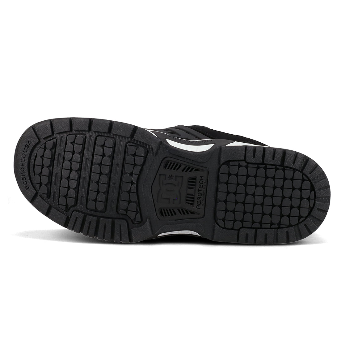 The bottom view of the Men’s AT-2 Shoes by DC Shoes showcases a black outsole with textured tread patterns, featuring the DC Shoes logo at the center and RESIST+COLOR text on the heel. Visible grooves provide grip for cushioned impact and enhanced support, while integrated AEROTECH ventilation channels offer breathable comfort—all set against a white background.