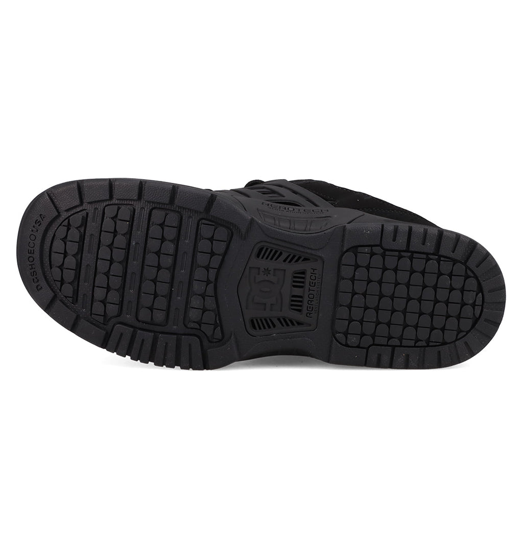 The image shows the black rubber sole of the Men's AT-2 Shoes by DC Shoes, featuring a textured tread pattern with the DC logo in the center and AEROTECH ventilation for breathability.