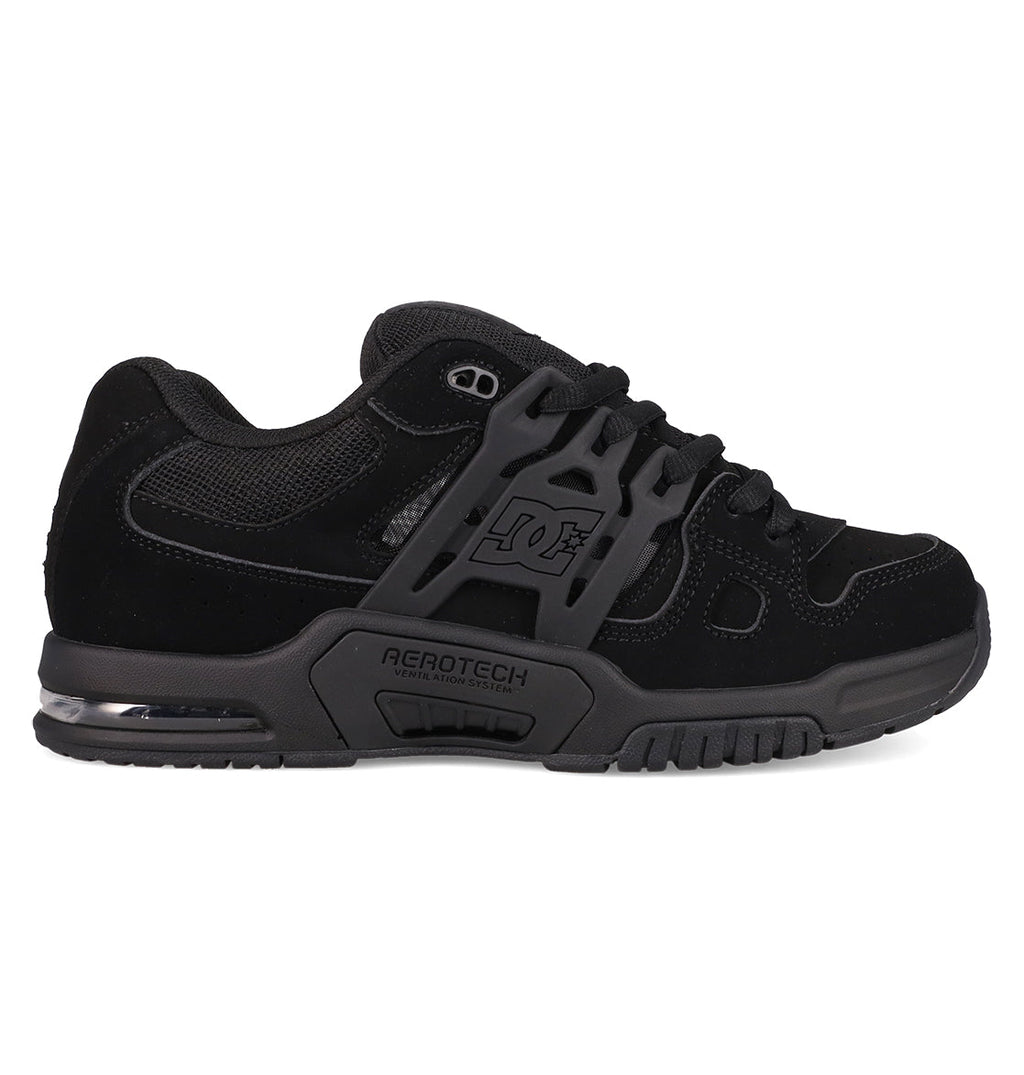The Men's AT-2 Shoes by DC Shoes feature a black skate design with dark gray accents, mesh and suede uppers, a thick padded tongue, chunky sole, DC logo on the side, and AEROTECH branding to showcase its breathable AEROTECH ventilation system.