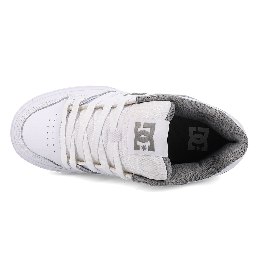 Top view of the Women’s Pure Shoe by DC Shoes, featuring a white upper with gray inner lining, white laces, and a gray DC logo on the tongue. The shoe showcases perforations on the toe for breathability and provides lightweight cushioning to enhance comfort with every step.