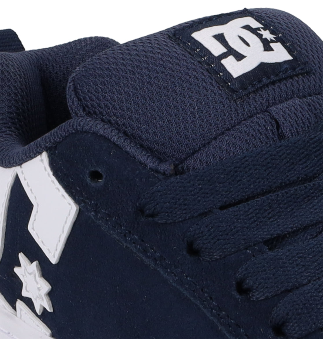 Here’s a rewritten sentence using the provided product data: Close-up of the DC Shoes Kids’ Court Graffik Shoes in navy blue with white accents and DC branding on the tongue and side. This children’s sneaker showcases a puffy silhouette inspired by the iconic Court Graffik design, featuring matching navy blue laces and a textured upper.