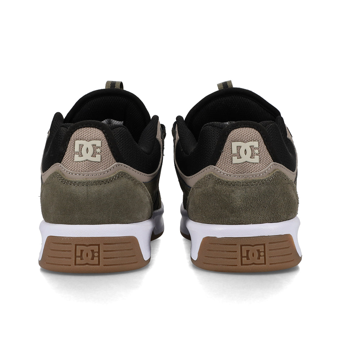Back view of a pair of DC Shoes Men’s Kalynx Zero sneakers, featuring black, brown, and olive green panels, white midsoles, and brown outsoles. The DC logo appears on the heel and sole of each shoe.
