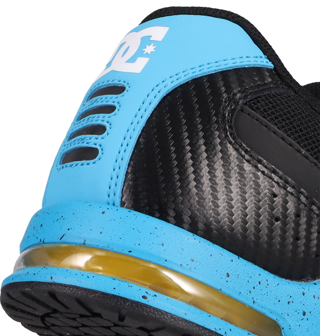 Close-up of the heel of the DC Shoes Men's AT-2, showing a blue heel section with black dotted texture, visible air-cushioned outsole, and part of the white DC logo on the blue heel tab.