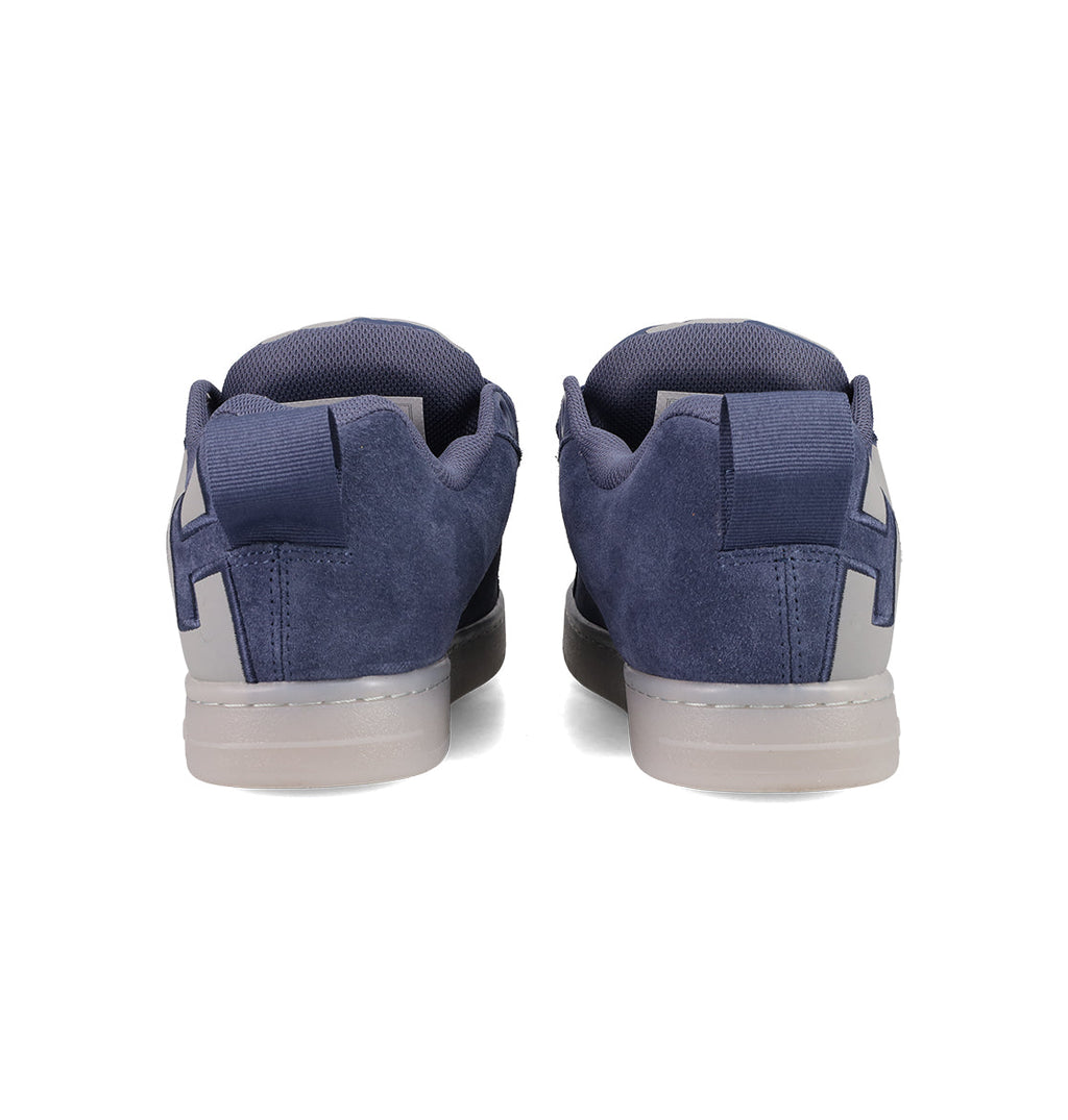The Men's Court Graffik Shoes by DC Shoes are navy blue suede sneakers with a puffy silhouette, gray heel accents, and a light gray rubber sole, shown from the back against a white background.