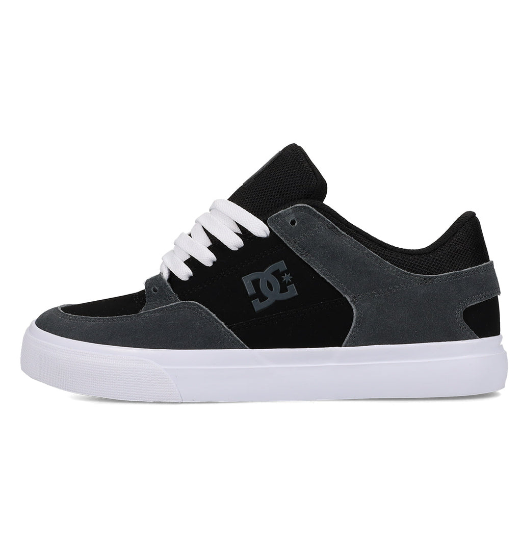A men’s Onyx skate shoe by DC Shoes in black and gray, featuring white laces, a white sole, the signature DC logo on the side, and a low-top silhouette crafted from suede and mesh for a minimalist look.