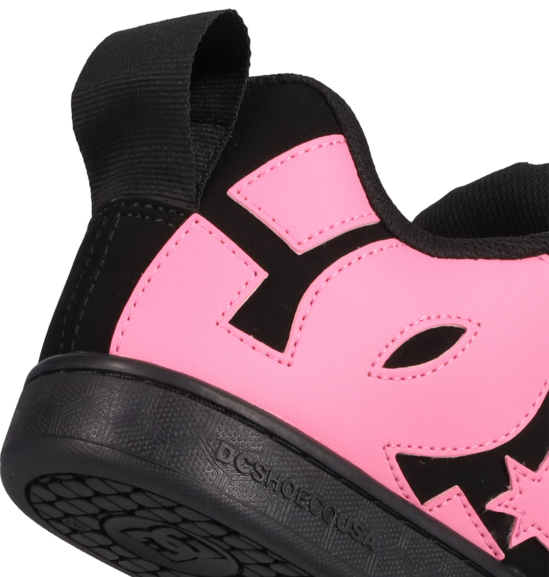 Close-up of the Women's Court Graffik Puff Shoes by DC Shoes—black and pink sneakers with a bold pink DC logo, black pull tab, and textured sole embossed with DCSHOECOUSA. Puffy silhouette makes them perfect statement footwear.