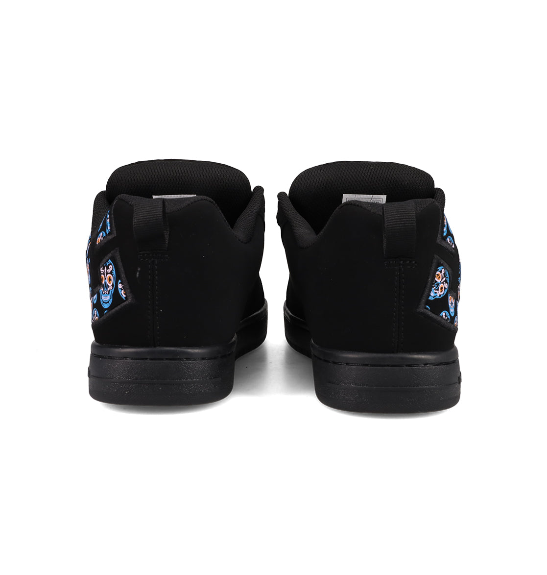 A pair of DC Shoes Men’s Court Graffik Day Of The Dead sneakers in black, viewed from the back, showcasing vibrant Día de los Muertos-inspired decorative designs on the heels against a plain white background, part of the exclusive Day of the Dead Collection.
