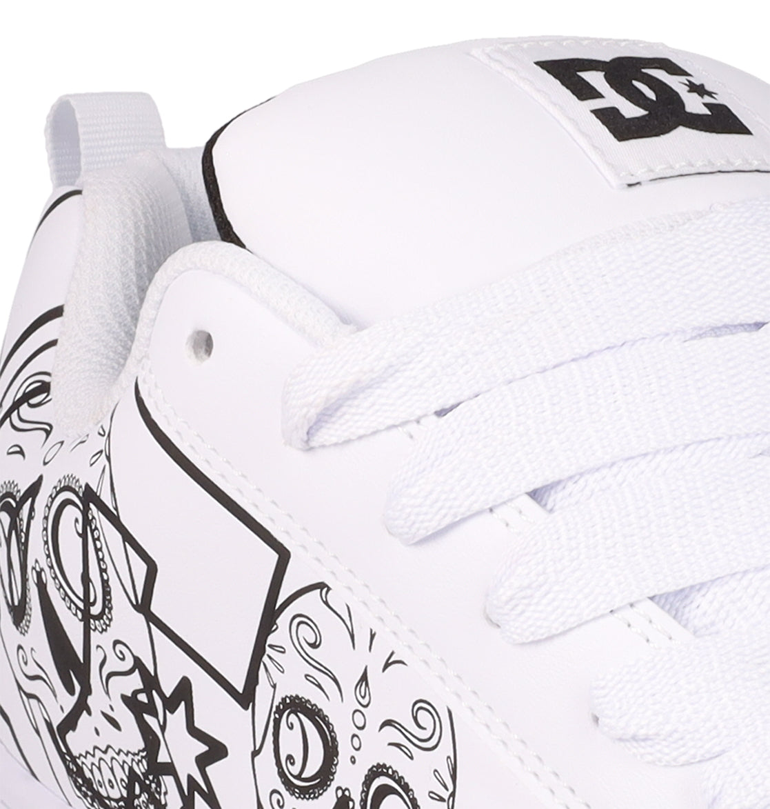 Close-up of the DC Shoes Men’s Court Graffik Day Of The Dead sneaker, showcasing black outlined doodle designs, white laces, and a DC Shoes logo on the tongue—a creative homage to Día de los Muertos.