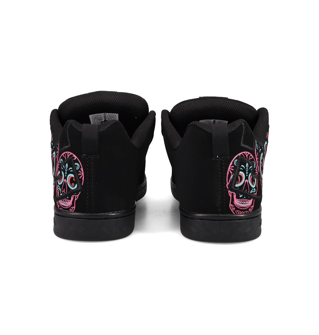 A pair of Women’s Court Graffik Day Of The Dead sneakers by DC Shoes viewed from the back, showcasing vibrant sugar skull designs in pink, teal, and white on the heels—a bold and striking addition to any Día de los Muertos Day of the Dead collection.