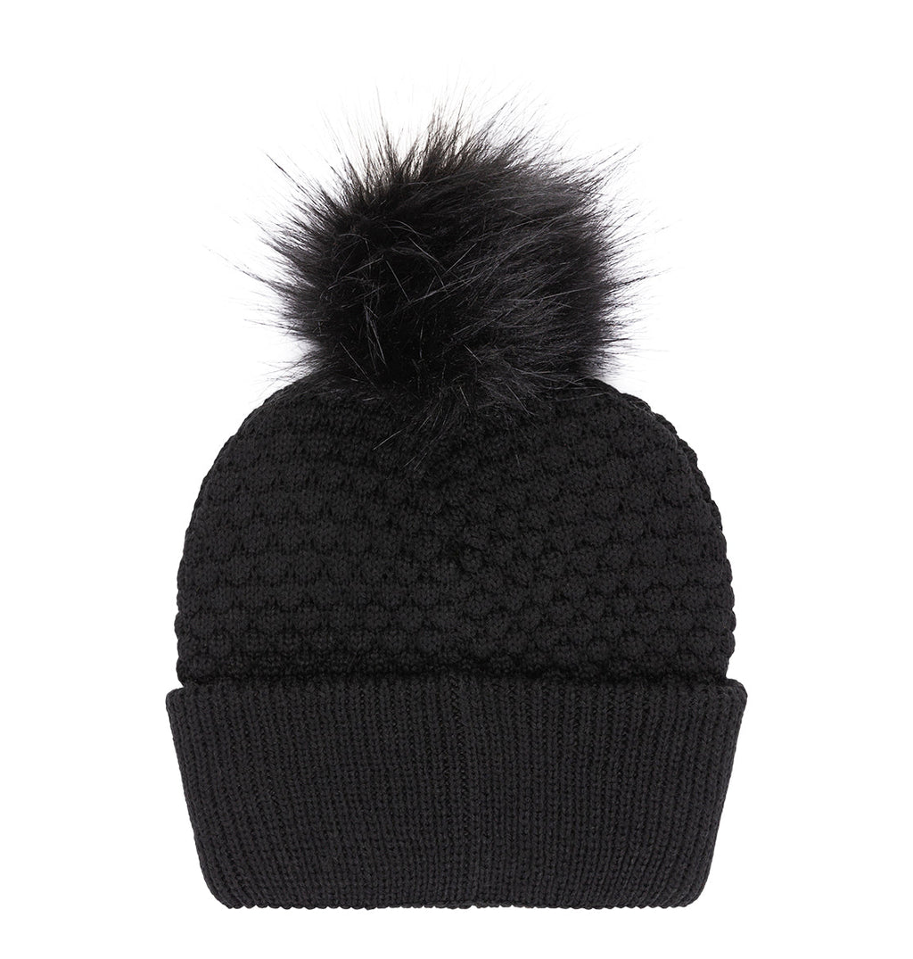 Black knit DC Shoes Women’s Splendid Beanie featuring a large, fluffy pom-pom on top and a folded ribbed brim, displayed on a white background.