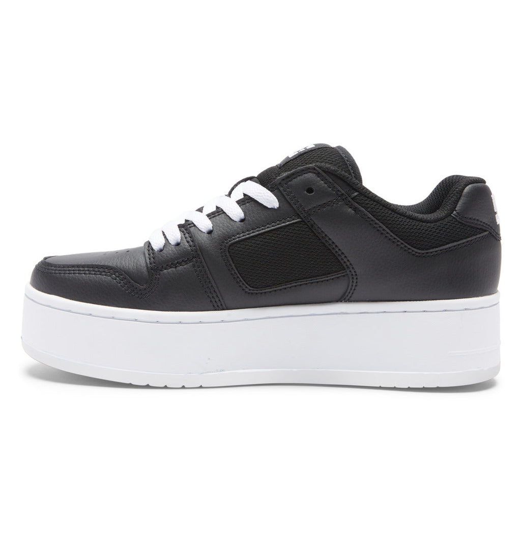 A side view of the Women’s Manteca 4 Platform Shoes by DC Shoes displays a black sneaker with white laces and a thick white platform sole, set against a plain white background and combining modern style with comfort for women.