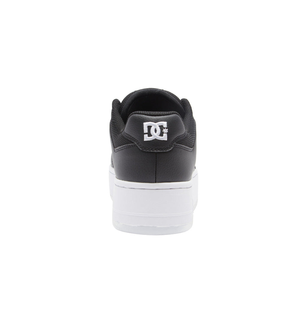 A rear view of the Women’s Manteca 4 Platform Shoes by DC Shoes, featuring a black upper and white sole. The white DC Shoes logo stands out on the heel against the plain white background, emphasizing these stylish women’s sneakers.