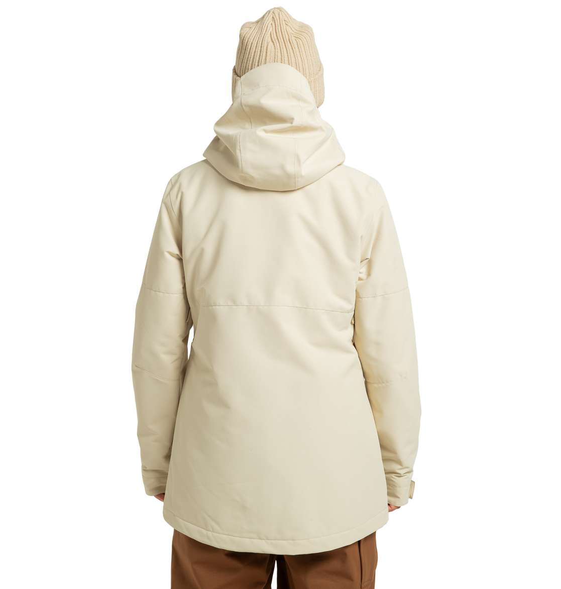 A person is shown from behind, standing against a plain white background, wearing a cream-colored DC Shoes Women’s Cruiser Insulated Jacket made from recycled polyester. The jacket features advanced weather defense technology for added protection and is paired with a tan knit beanie and brown pants.