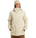 A person stands against a plain white background with hands in the pockets of the DC Shoes Women’s Cruiser Insulated Jacket—a beige, hooded winter jacket paired with a matching knit beanie. Made from recycled polyester and enhanced with weather defense technology.