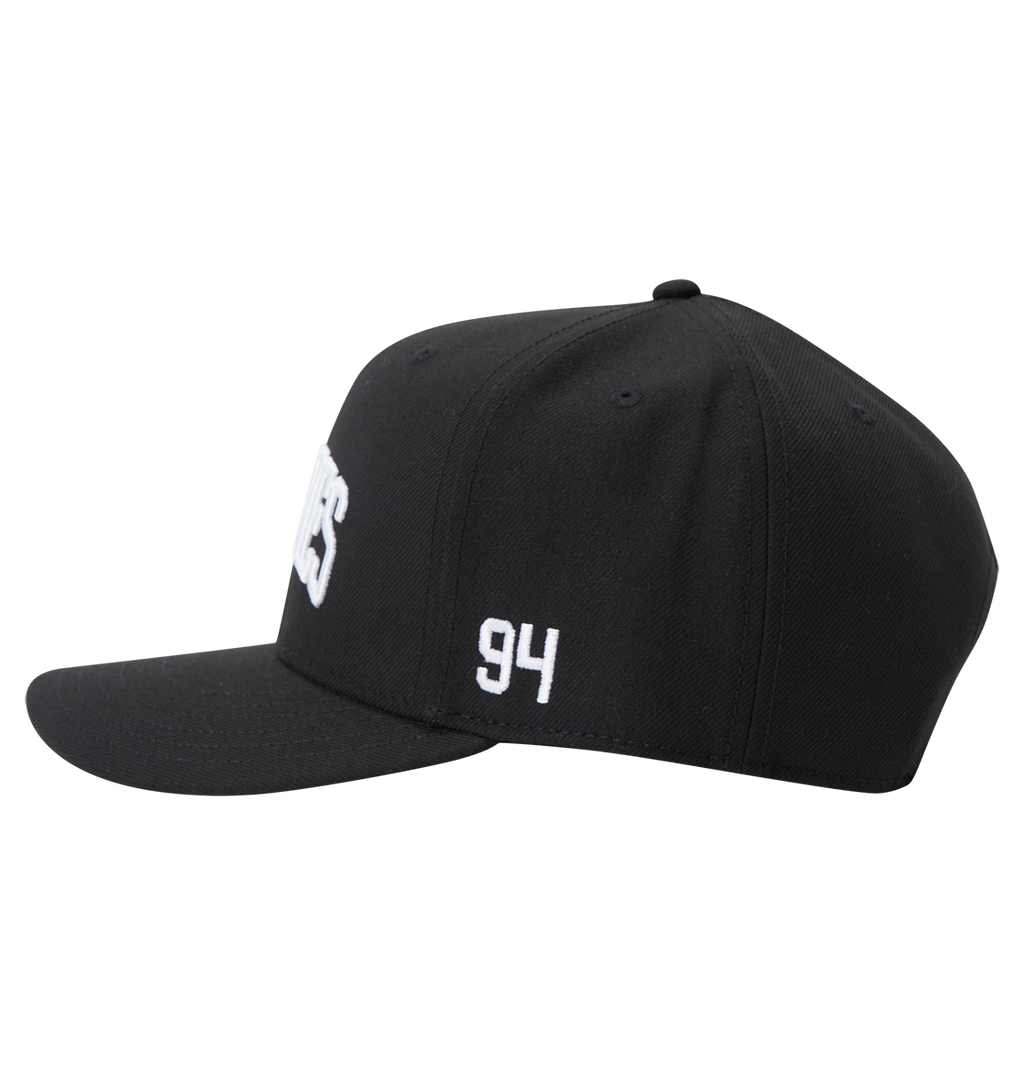 The DC Shoes Men's Semi-Pro Snapback is a black flat-brim hat with "94" embroidered in white on the side, partially visible white text on the front, and an adjustable fit for comfort. Shown from the left side.