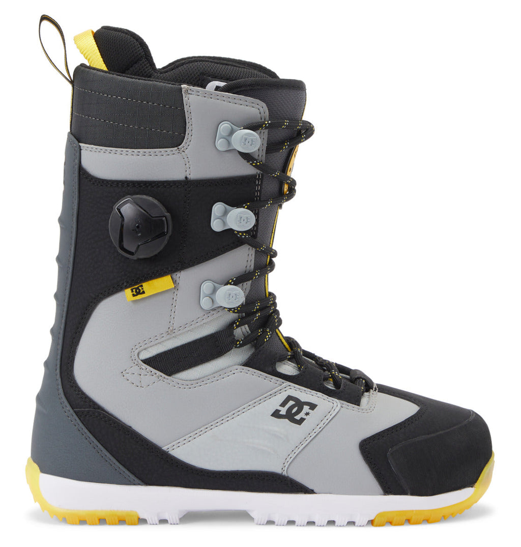 Introducing the Men’s Premier Hybrid BOA® Snowboard Boots by DC Shoes—crafted in a stylish combination of gray, black, and yellow. These boots showcase the advanced BOA® Fit System with a sleek black dial and gray laces, complemented by a rugged sole for exceptional durability. The DC Shoes logo appears on the side near the heel, underscoring their high-performance Premier Hybrid design.