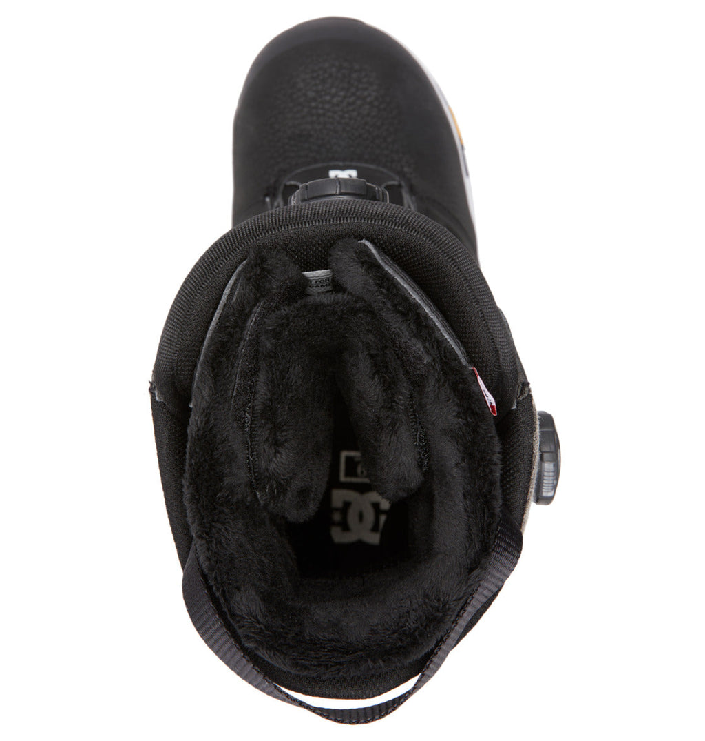 Top view of the DC Shoes Men’s Judge BOA® Snowboard Boots, showcasing a black winter style with a plush, furry inner lining and an easy-to-use round BOA® dial closure system on the side. Engineered for both performance and comfort, these boots feature a rugged Vibram outsole that delivers superior traction on icy terrain.