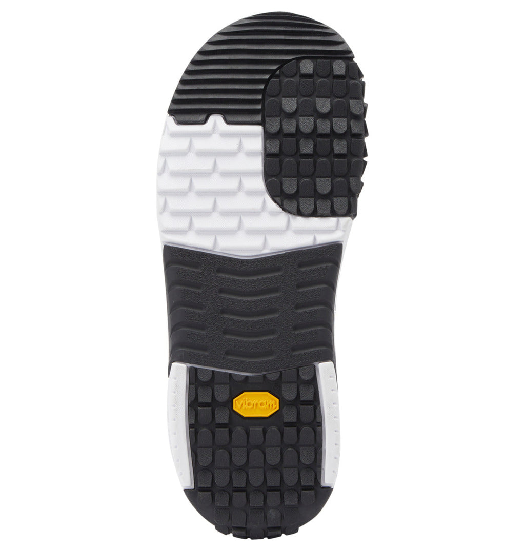 The image shows the black, white, and gray treaded sole of a Men’s Judge BOA® Snowboard Boot by DC Shoes viewed from underneath, featuring a yellow Vibram outsole logo near the heel.