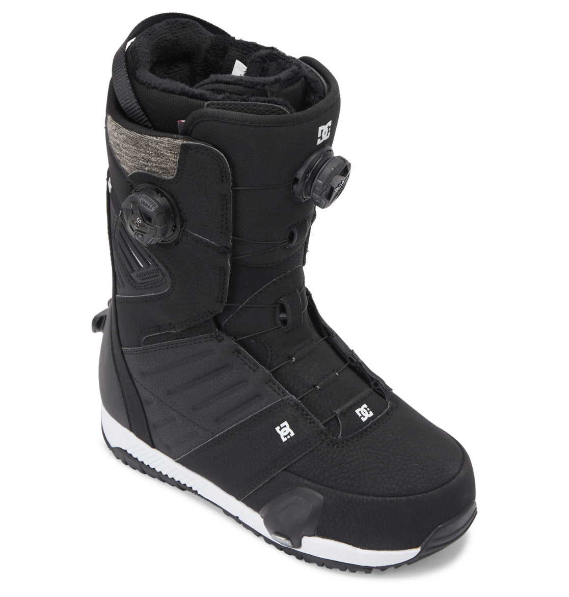 The Men’s Judge Step On® BOA® Snowboard Boots from DC Shoes feature a high-ankle black design with dual BOA® Fit System dials for precise tightening, textured panels, and DC branding on the side and foot. The boots have a white sole with a contrasting black tread pattern.