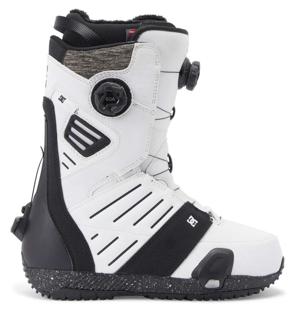 A pair of DC Shoes Men’s Judge Step On BOA® Snowboard Boots in a white and black colorway, featuring textured details, ventilation slits, a BOA® Fit System dial closure, and a rugged black sole. The boot is positioned upright and viewed from the side.