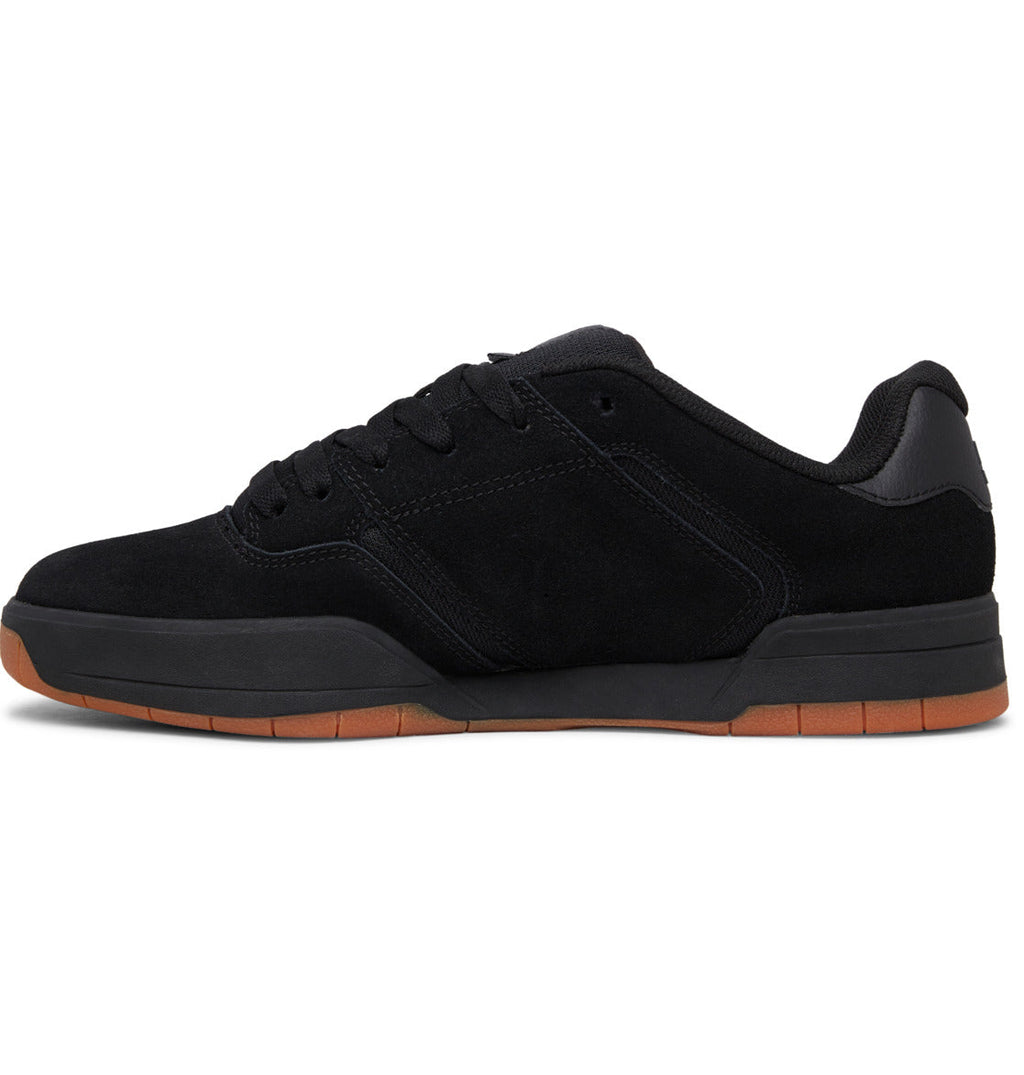 A side view of the DC Shoes Men’s Central Shoes, a black low-top sneaker with a gum rubber cupsole, shown against a white background. This shoe features black laces, subtle branding, and combines classic style with durability.
