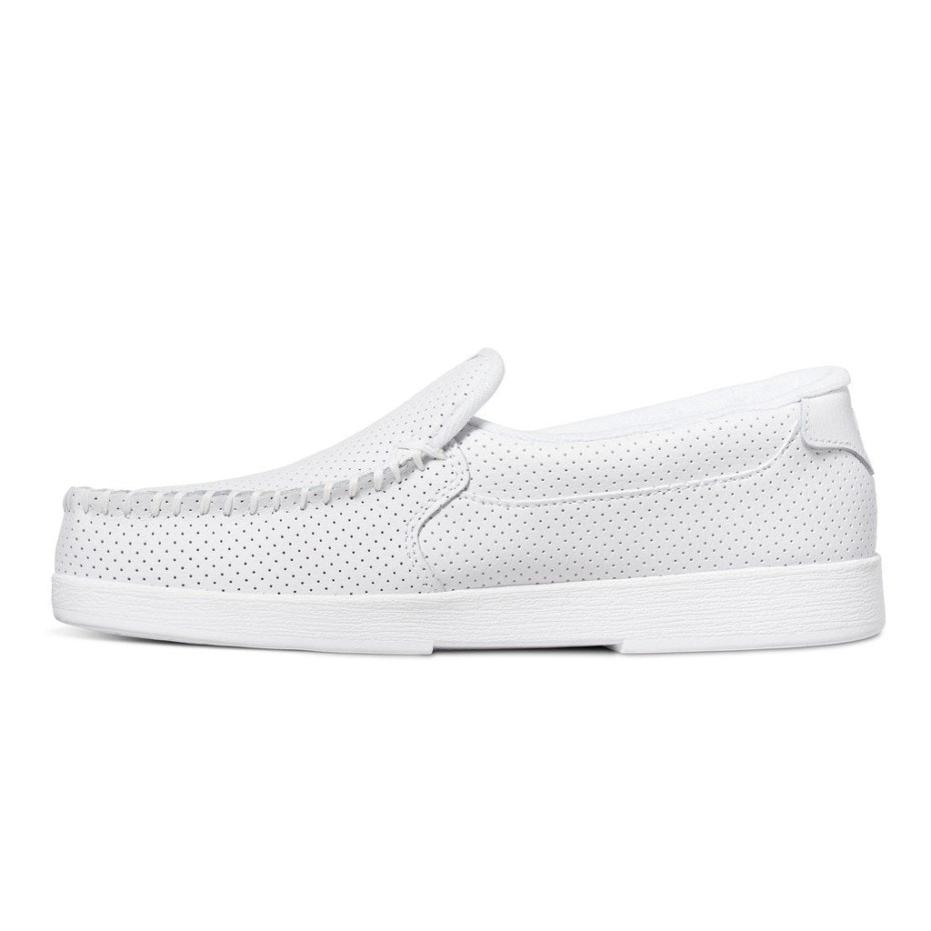 The DC Shoes Men’s Villain Slip-On Shoes, featuring a white perforated design and a textured sole for added grip, are shown in a side profile on a white background. These lightweight casual loafers have a low heel and an easy slip-on construction.