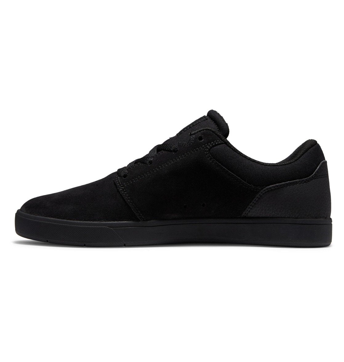 A side-profile view of the DC Shoes Men’s Crisis 2, a black low-top sneaker featuring a suede finish, black laces, and a performance cup sole, highlights how these skate shoes seamlessly combine style and function against a white background.
