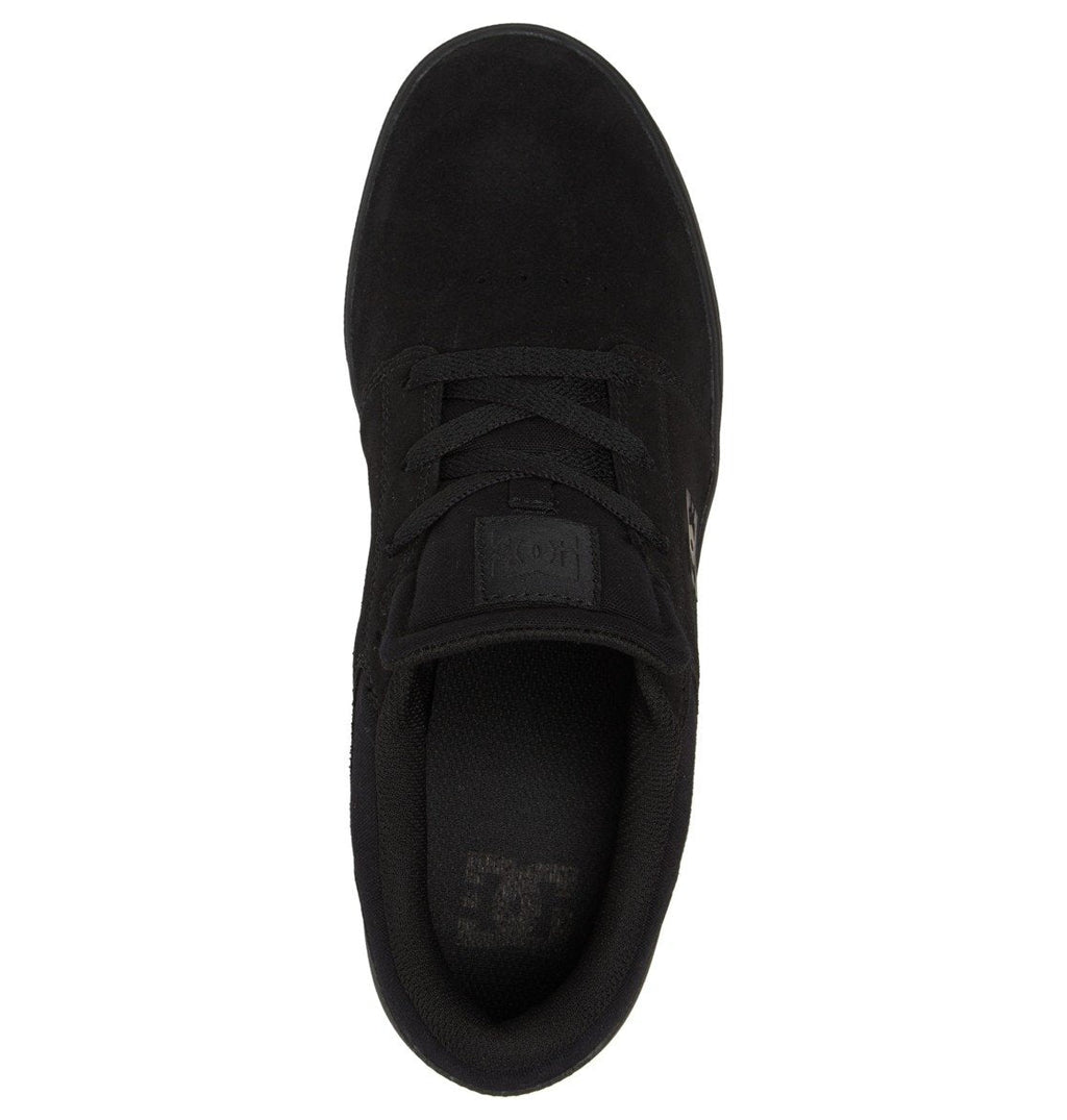 A top-down view of the Men’s Crisis 2 Shoes by DC Shoes in black highlights the laces, a tongue featuring the DC logo, and a padded collar. These skate shoes offer a clean, minimalist look without any bold patterns or colors and are built with a durable performance cupsole for enhanced longevity.