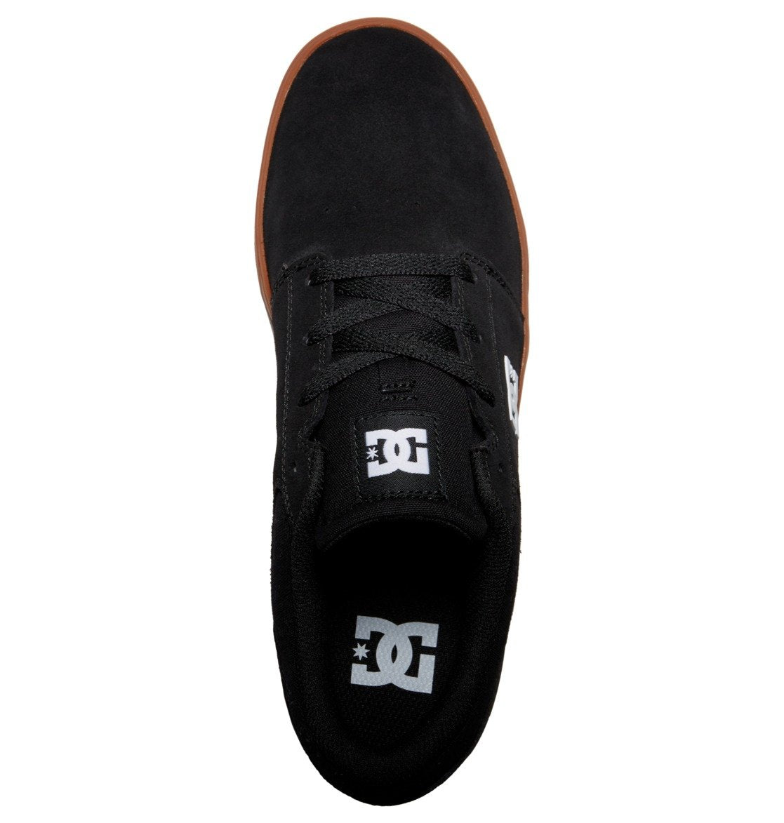 Top view of the Men’s Crisis 2 Shoes from DC Shoes, showcasing a sleek black suede or canvas upper with matching black laces and the distinctive white DC Shoes logo on both the tongue and insole. Featuring a durable brown performance cup sole that provides excellent grip, these shoes offer outstanding style and quality at an affordable price point, making them an ideal choice for budget-conscious skaters.