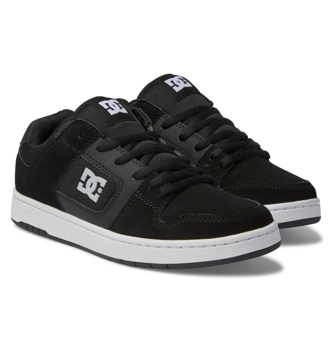 Showcasing the Men’s Manteca 4 Shoes from DC Shoes, this pair features a sleek black design with white soles, black laces, and bold white DC branding on both the side and tongue. The skate shoes are presented at an angle to highlight their performance-focused construction from both side and top perspectives.