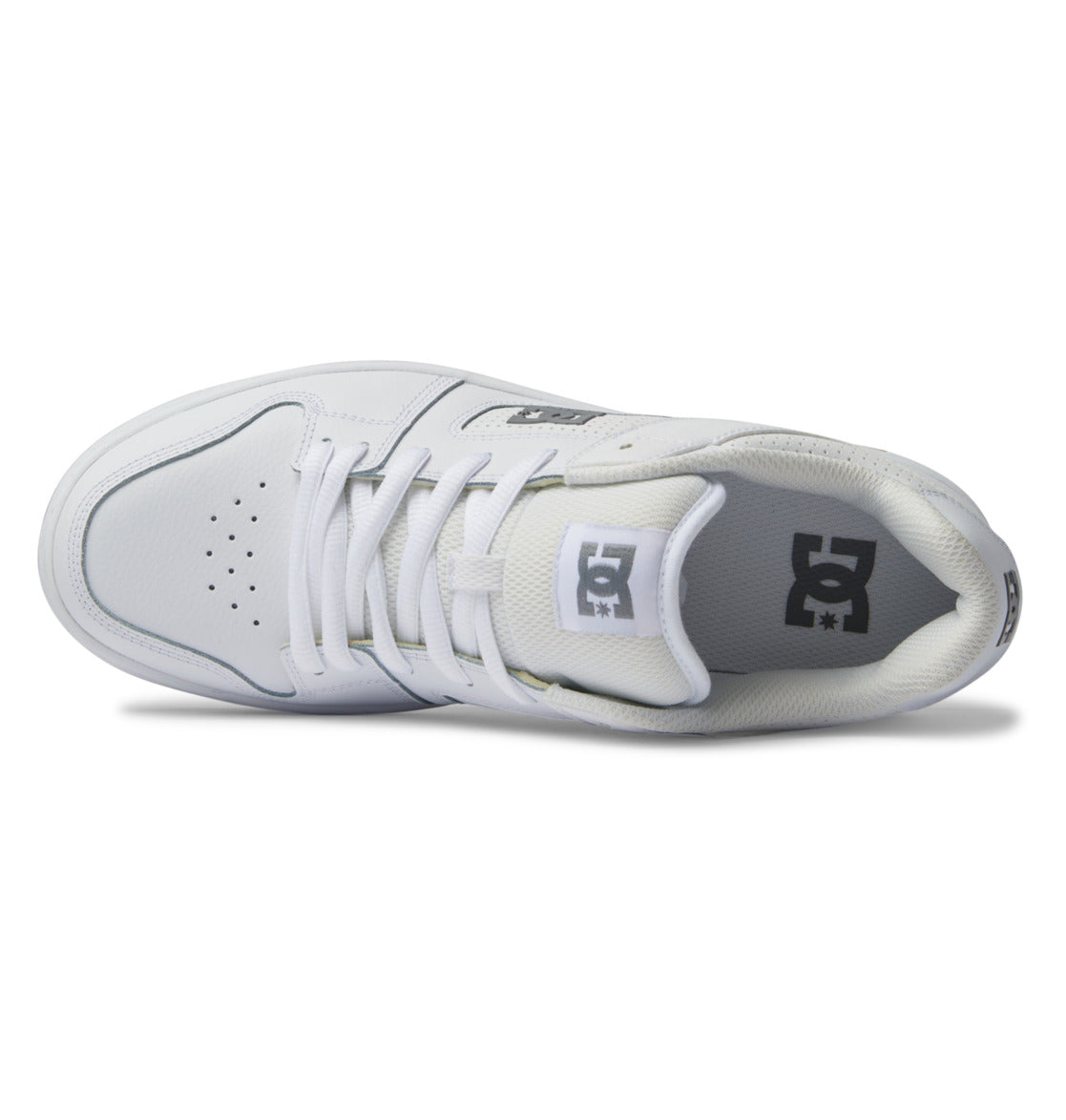 A top-down view of the white DC Shoes Men’s Manteca 4 showcases its laces, perforated toe box, and padded tongue featuring the gray DC logo—an ideal pick for fans of stylish skate footwear.