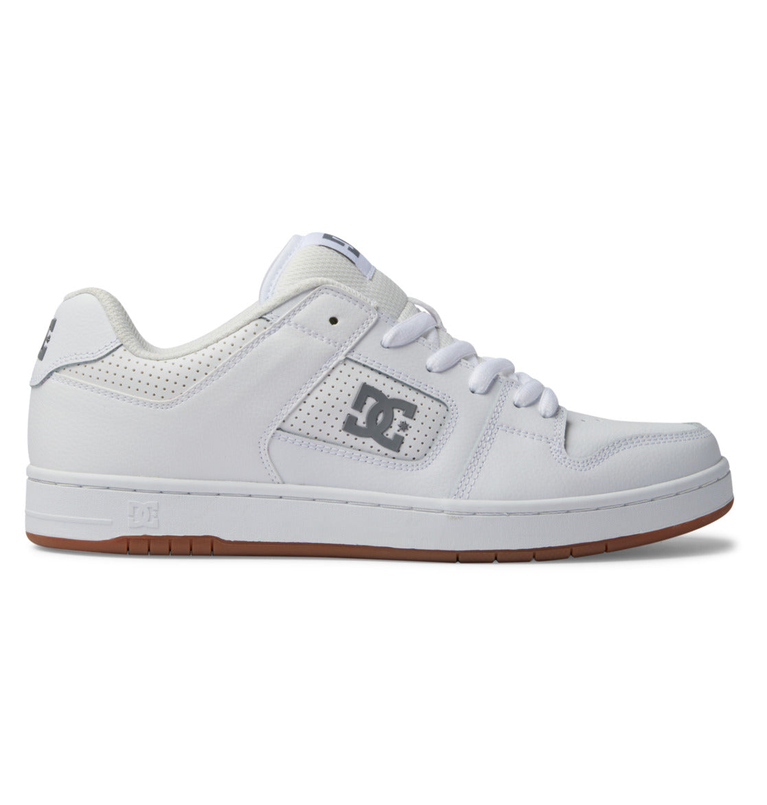 The DC Shoes Men’s Manteca 4 Shoes are white low-top sneakers featuring a gum sole, white laces, perforated detailing, and the DC Shoes logo in gray on the side. Designed as a versatile skate shoe, they combine classic style with modern performance features.