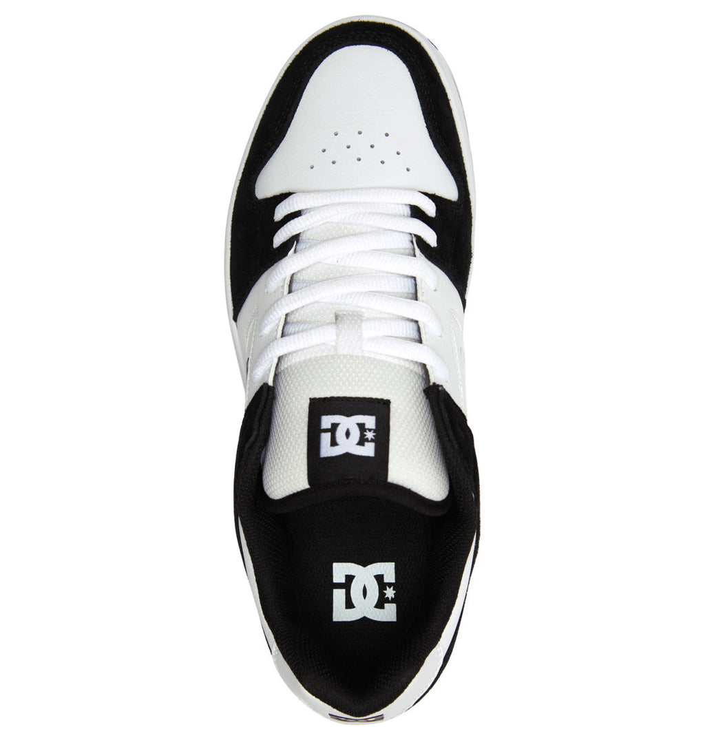 Top view of the Men’s Manteca 4 Shoes by DC Shoes in black and white, featuring white laces, a perforated white toe, and DC Shoes branding on the black tongue and insole—engineered for modern comfort.