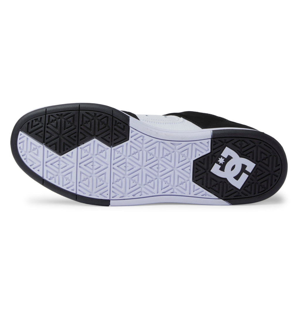 The outsole of the Men’s DC Cure Shoes by DC Shoes is shown from the bottom, featuring a black and white geometric tread pattern with the iconic DC logo near the heel—creating a stylish and durable option for everyday wear.