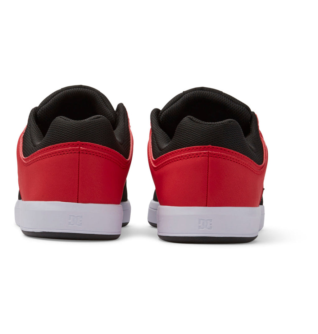 A pair of Men’s DC Cure Shoes by DC Shoes, in a stylish red and black colorway with a leather upper, are shown from the back. They feature crisp white soles and are set against a white background—making them an ideal choice for everyday wear.