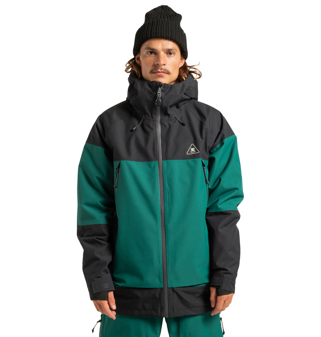 A person stands facing forward with hands by their sides against a plain white background, prepared for any weather on their next adventure in the DC Shoes Unisex Intel 30K Insulated Jacket.